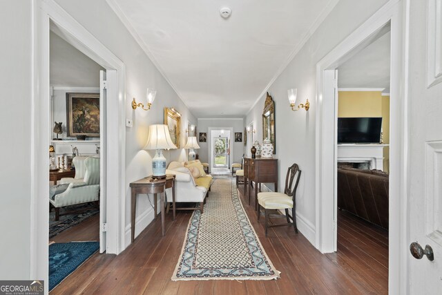 hallway with ornamental molding and dark hardwood / wood-style floors