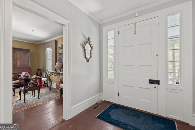 foyer entrance featuring ornamental molding and dark hardwood / wood-style flooring