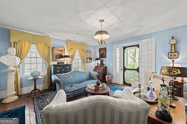 living room featuring ornamental molding, hardwood / wood-style floors, and an inviting chandelier