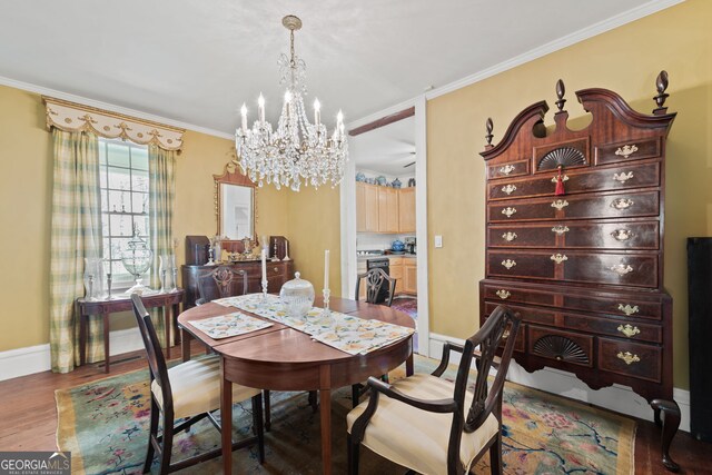 dining area with a notable chandelier, ornamental molding, and hardwood / wood-style floors