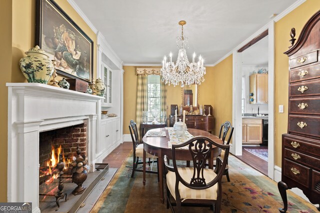 dining space featuring an inviting chandelier, crown molding, and dark hardwood / wood-style floors