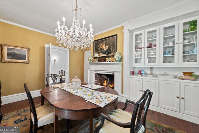 dining space featuring dark hardwood / wood-style flooring, a brick fireplace, and crown molding