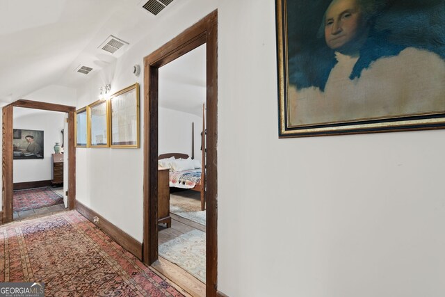 hallway featuring vaulted ceiling