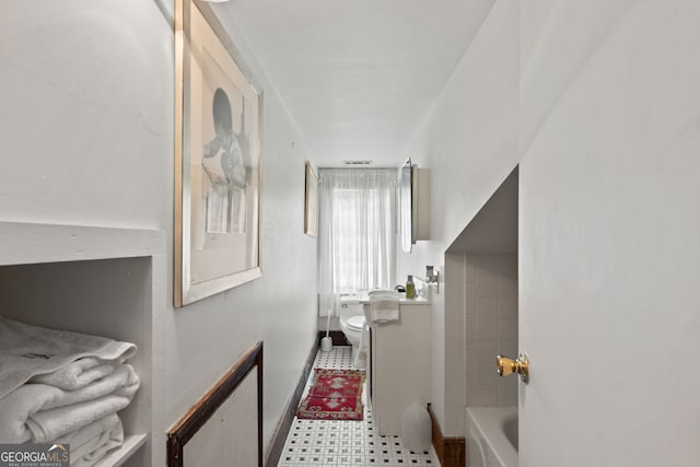 bathroom with toilet and a bathtub