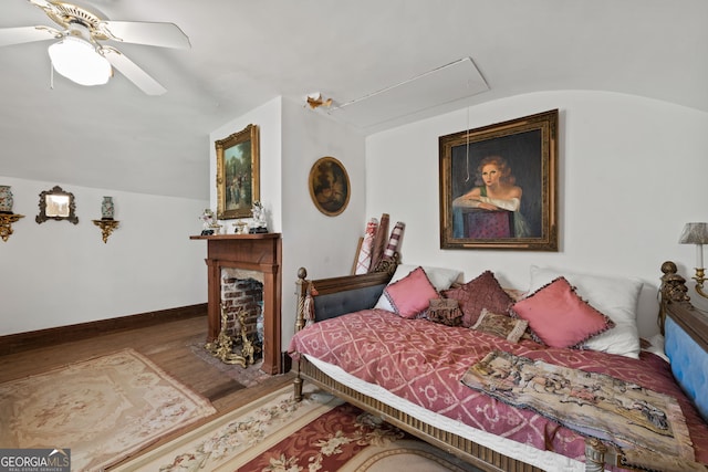 bedroom with ceiling fan, lofted ceiling, and hardwood / wood-style flooring