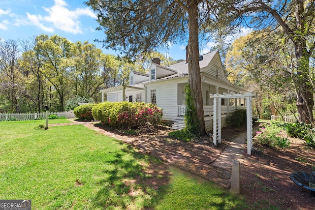 view of property exterior featuring a lawn and a pergola