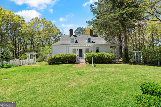 back of house with a lawn