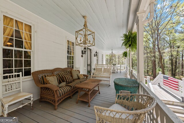 wooden deck featuring an outdoor hangout area and a porch