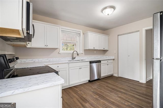 kitchen featuring sink, white cabinetry, light stone countertops, dark hardwood / wood-style floors, and appliances with stainless steel finishes