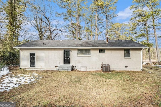 back of house with a lawn