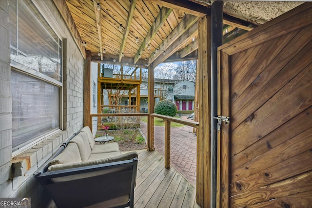 sunroom / solarium featuring wood ceiling and vaulted ceiling with beams