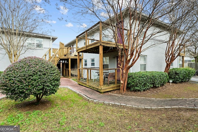 rear view of house featuring a deck