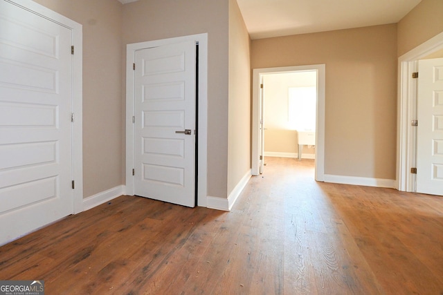 interior space with hardwood / wood-style flooring and baseboards