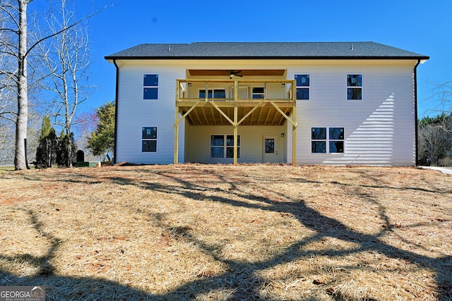 back of property featuring a balcony and a ceiling fan