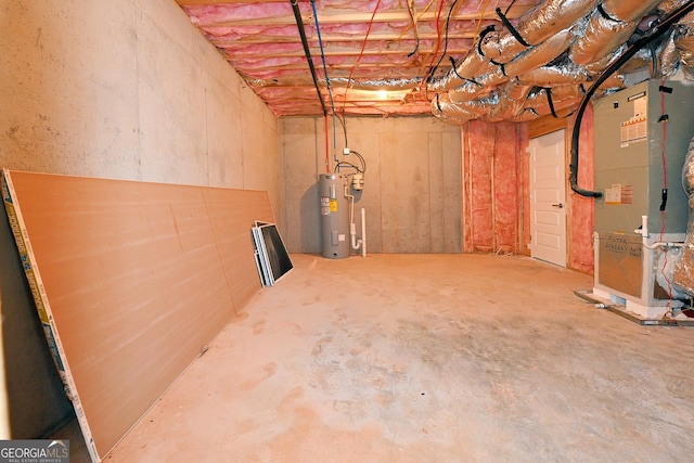 unfinished below grade area with electric water heater and heating unit