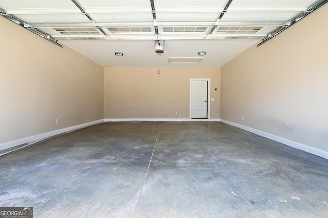 garage featuring baseboards and a garage door opener