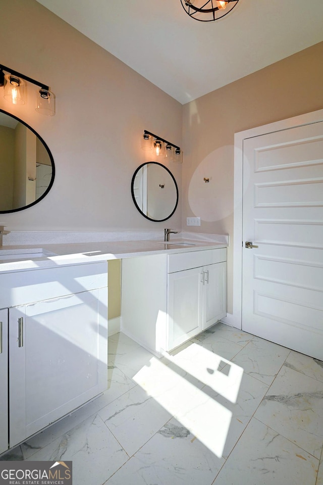 full bath featuring marble finish floor, a sink, and double vanity