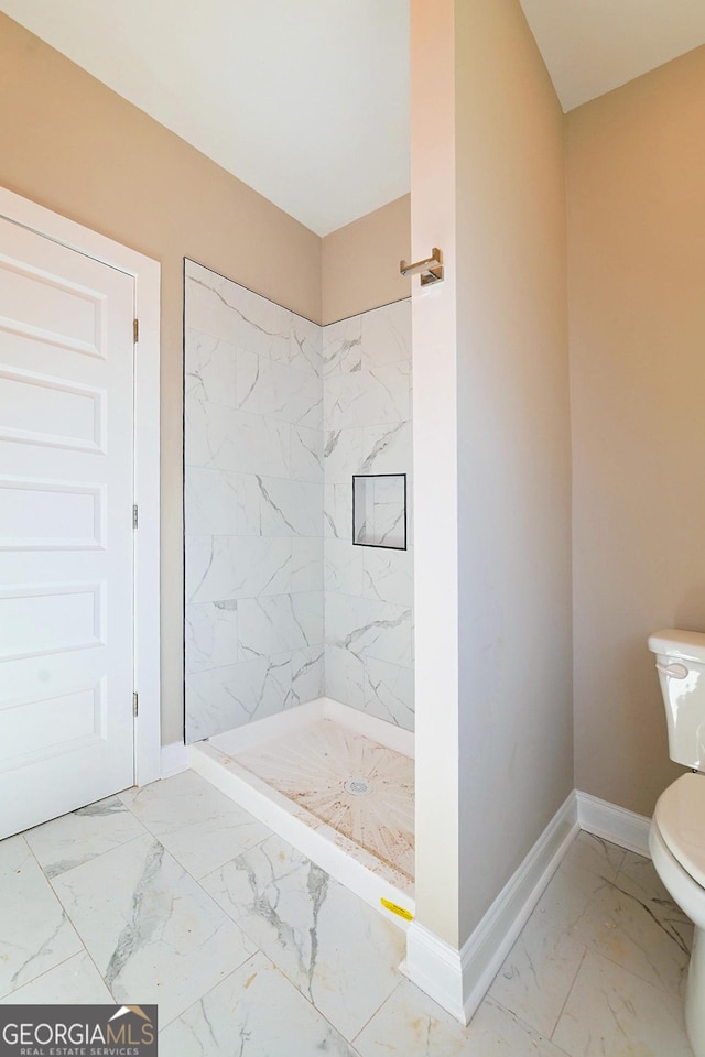 full bath featuring a stall shower, marble finish floor, baseboards, and toilet