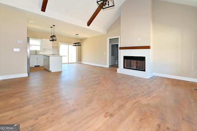 unfurnished living room featuring light wood-style floors, a fireplace, and baseboards