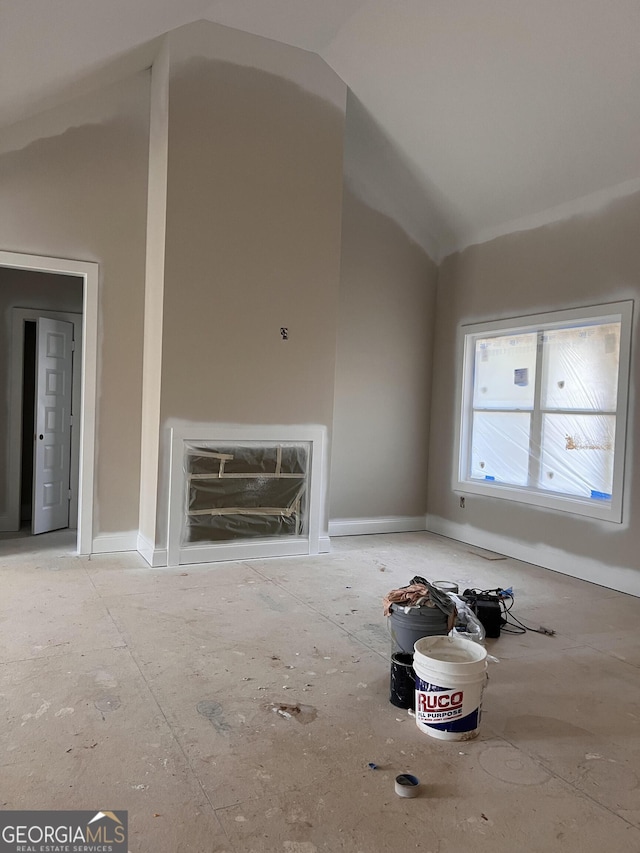 unfurnished living room with vaulted ceiling