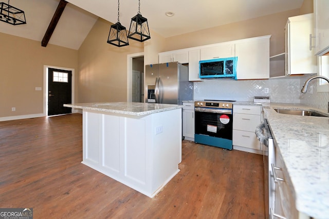 kitchen with a center island, pendant lighting, appliances with stainless steel finishes, white cabinets, and a sink