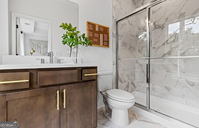 bathroom with toilet, a shower with door, and vanity