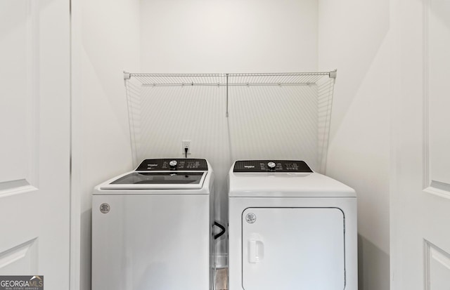 clothes washing area featuring washing machine and clothes dryer