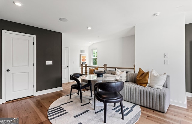 interior space featuring vaulted ceiling and light hardwood / wood-style flooring