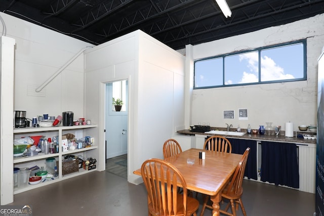 dining area with sink, concrete flooring, and plenty of natural light