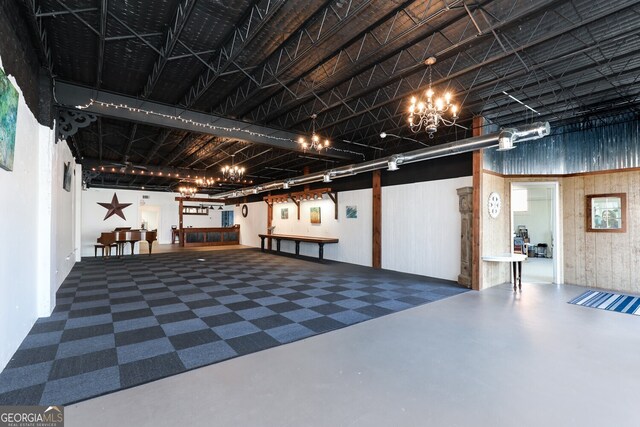 basement with wood walls and a chandelier