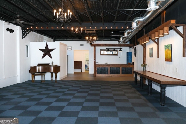 interior space with ceiling fan with notable chandelier