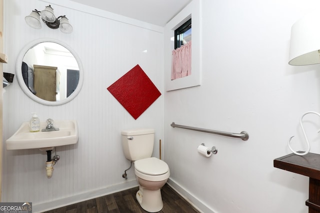 bathroom featuring wood-type flooring, sink, and toilet