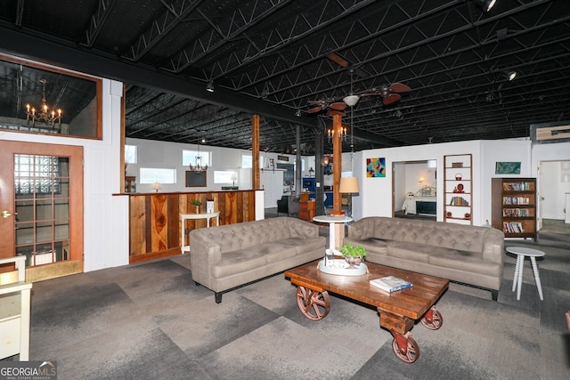 living room with wood walls and a notable chandelier