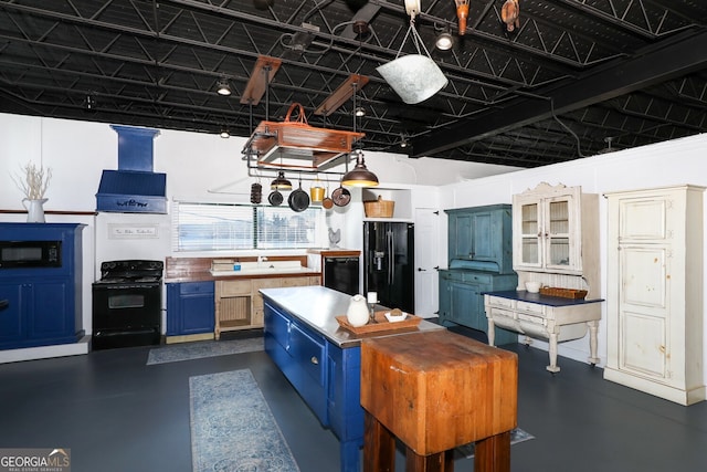 kitchen featuring black appliances, blue cabinetry, and wall chimney range hood