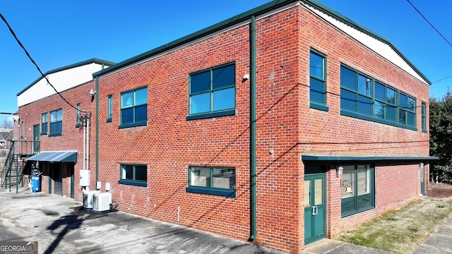 view of building exterior with central AC unit