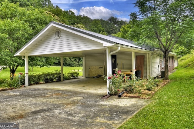 view of parking featuring a yard and a carport