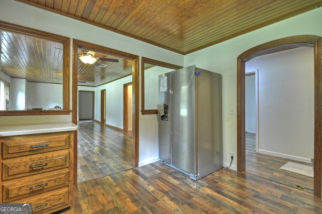 interior space featuring ornamental molding, ceiling fan, and dark hardwood / wood-style floors