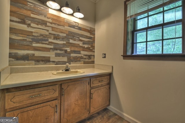 bathroom featuring hardwood / wood-style floors, a healthy amount of sunlight, and vanity