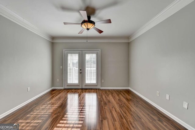 spare room featuring ceiling fan, dark wood-type flooring, crown molding, and french doors