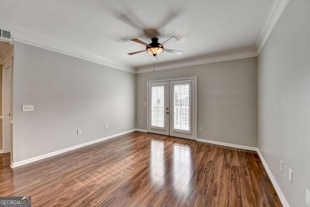 empty room with ceiling fan, french doors, dark hardwood / wood-style flooring, and crown molding