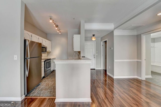 kitchen featuring stainless steel appliances, dark hardwood / wood-style floors, crown molding, white cabinets, and sink