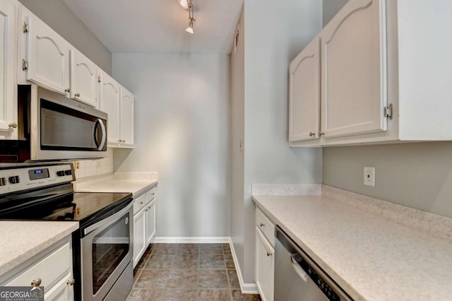 kitchen with white cabinets, stainless steel appliances, and rail lighting