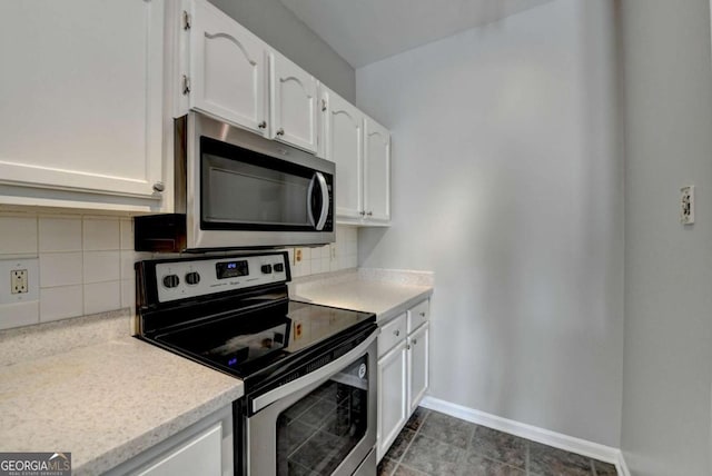 kitchen with decorative backsplash, white cabinetry, and stainless steel appliances