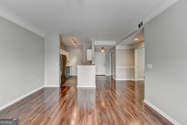 unfurnished living room featuring dark hardwood / wood-style flooring and crown molding