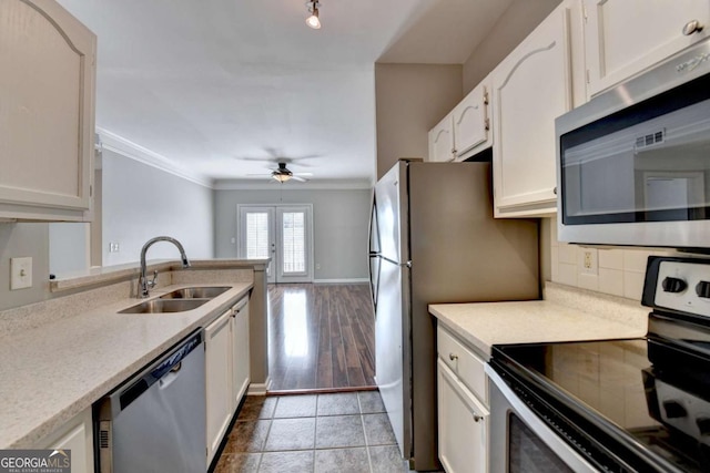 kitchen with white cabinets, french doors, appliances with stainless steel finishes, and sink