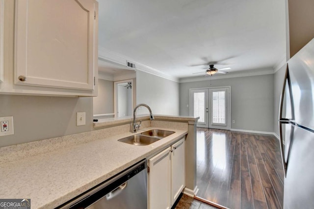 kitchen featuring ceiling fan, sink, white cabinets, and stainless steel appliances