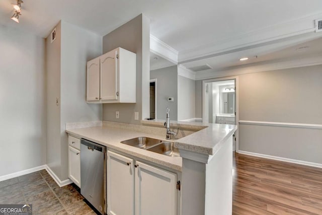 kitchen with kitchen peninsula, stainless steel dishwasher, white cabinets, and sink