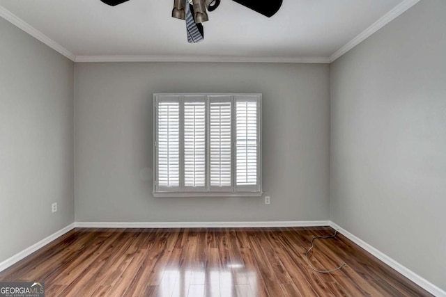 empty room featuring ceiling fan, crown molding, and dark hardwood / wood-style floors