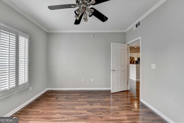 spare room featuring ceiling fan, ornamental molding, and hardwood / wood-style floors