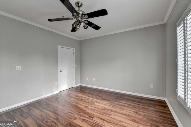 unfurnished room featuring ceiling fan, a wealth of natural light, dark hardwood / wood-style floors, and crown molding